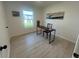 A bright room features a desk with a chair, wood-look flooring, and white walls at 654 Nw 9Th Ave, Webster, FL 33597