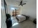 A bright bedroom features wood-look flooring, a screen and decor at 654 Nw 9Th Ave, Webster, FL 33597
