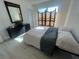 A bright bedroom features wood-look flooring, a screen and decor at 654 Nw 9Th Ave, Webster, FL 33597