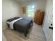 A charming bedroom featuring wood-look flooring and natural light at 654 Nw 9Th Ave, Webster, FL 33597