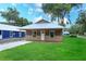 Inviting home with a metal roof, covered porch, and lush green lawn at 654 Nw 9Th Ave, Webster, FL 33597