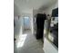 A bright laundry room features a stacked washer/dryer and a water heater at 654 Nw 9Th Ave, Webster, FL 33597