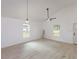 Bright living room with two windows, ceiling fan, and modern wood-look flooring at 654 Nw 9Th Ave, Webster, FL 33597
