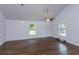 Bright and airy living room featuring wood floors, vaulted ceilings, and large windows at 654 Nw 9Th Ave, Webster, FL 33597