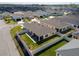 Aerial view of the property showcasing its well-maintained backyard with a screened lanai and lush landscaping at 6576 Merrill Ln, The Villages, FL 34762