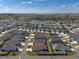 Aerial view of the neighborhood showcasing the property and surrounding community with a nearby pond at 6576 Merrill Ln, The Villages, FL 34762