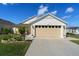 Charming single-story home featuring a well-manicured lawn and a two-car garage at 6576 Merrill Ln, The Villages, FL 34762