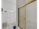 Bathroom featuring a white door with a window, a toilet, and a gold-trimmed shower at 726 Grand Vista Trl, Leesburg, FL 34748