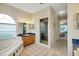 Bathroom with a soaking tub, enclosed shower, single vanity sink, and framed window for natural light at 726 Grand Vista Trl, Leesburg, FL 34748