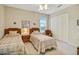 Bright bedroom features two twin beds, a ceiling fan, a window with blinds, and a closet at 726 Grand Vista Trl, Leesburg, FL 34748