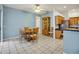 Cozy dining area with wood table, cabinet, and tile flooring adjacent to kitchen at 726 Grand Vista Trl, Leesburg, FL 34748