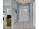 Bright entryway featuring tile flooring and a decorative light fixture, leading to other parts of the home at 726 Grand Vista Trl, Leesburg, FL 34748