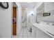 White laundry room with a washer, dryer, sink, and a view into an adjacent area at 726 Grand Vista Trl, Leesburg, FL 34748