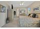 Full bedroom view showcasing the ensuite bathroom, large television, dresser, and windows with natural light at 726 Grand Vista Trl, Leesburg, FL 34748