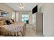 Angle view of bedroom with sliding glass doors opening to a patio and pool with television and dresser at 726 Grand Vista Trl, Leesburg, FL 34748