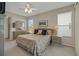 Bright main bedroom features neutral walls, a ceiling fan, and large windows for ample natural light at 726 Grand Vista Trl, Leesburg, FL 34748