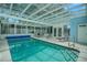 Indoor pool area with glass ceiling and plenty of seating at 726 Grand Vista Trl, Leesburg, FL 34748