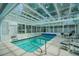 Enclosed pool area with glass ceiling and plenty of seating at 726 Grand Vista Trl, Leesburg, FL 34748