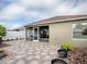 Nice backyard featuring stone flooring and leading to the screened in lanai at 796 Elliott Ave, The Villages, FL 32163