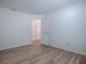 Bedroom features light wood-look flooring and doorway to another room at 796 Elliott Ave, The Villages, FL 32163