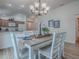 Bright dining area features a chandelier and seamlessly connects to the kitchen for entertaining at 796 Elliott Ave, The Villages, FL 32163