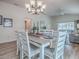 Stylish dining area open to the living room, features modern furniture, and durable wood flooring at 796 Elliott Ave, The Villages, FL 32163