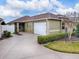 Charming single-story home featuring a two-car garage, well-maintained landscaping, and a cozy front entrance at 796 Elliott Ave, The Villages, FL 32163