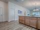 Spacious kitchen island with wood cabinets, drawers, and durable flooring perfect for cooking and gatherings at 796 Elliott Ave, The Villages, FL 32163