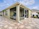 Exterior view of lanai with stone flooring and screened windows for outdoor living at 796 Elliott Ave, The Villages, FL 32163