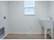 Laundry room featuring utility sink, window, hookups, and hardwood floor at 796 Elliott Ave, The Villages, FL 32163