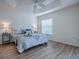 Bright main bedroom featuring stylish decor, neutral tones, tray ceiling, and ample natural light at 796 Elliott Ave, The Villages, FL 32163