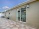 The patio features a unique patterned tile floor, and a sliding glass door provides access to the interior at 796 Elliott Ave, The Villages, FL 32163