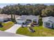 An aerial view of a home with a manicured lawn, and beautiful landscaping in a well-maintained neighborhood at 8373 Se 177Th Bartram Loop, The Villages, FL 32162