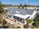 Aerial view of the home featuring a screened-in patio and landscaped backyard at 8373 Se 177Th Bartram Loop, The Villages, FL 32162