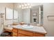 This primary bathroom features a sink with vanity, a large mirror, and neutral paint at 8373 Se 177Th Bartram Loop, The Villages, FL 32162