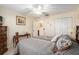 This bedroom features neutral walls, wood furniture, and a light fixture at 8373 Se 177Th Bartram Loop, The Villages, FL 32162