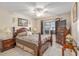 This bedroom is a relaxing retreat with neutral walls, soft lighting, and wood furniture at 8373 Se 177Th Bartram Loop, The Villages, FL 32162