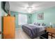 Cozy bedroom with a ceiling fan, neutral walls and a window with natural light at 8373 Se 177Th Bartram Loop, The Villages, FL 32162