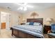 This spacious bedroom boasts a ceiling fan, neutral paint, and a door to an en-suite bathroom at 8373 Se 177Th Bartram Loop, The Villages, FL 32162