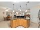 Kitchen island with breakfast bar and views into the dining and living areas at 8373 Se 177Th Bartram Loop, The Villages, FL 32162