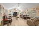 Bright living room with comfortable seating, a fireplace, and natural light at 8373 Se 177Th Bartram Loop, The Villages, FL 32162