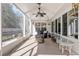 Enclosed back patio featuring a stone fire pit and white metal table and chairs at 8373 Se 177Th Bartram Loop, The Villages, FL 32162