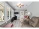 Comfortable sunroom featuring large windows, ceiling fan, and cozy seating area at 8373 Se 177Th Bartram Loop, The Villages, FL 32162