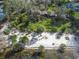 Expansive aerial view of waterfront home with private beach and mature landscaping at 840 2Nd St, Clermont, FL 34711