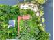 Aerial view of property, waterfront location, and well-maintained landscaping at 840 2Nd St, Clermont, FL 34711