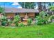 Tranquil backyard featuring a decorative fountain, lush greenery, and a charming stone patio for outdoor entertaining at 840 2Nd St, Clermont, FL 34711