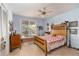 Comfortable bedroom with a classic wooden bed frame, ceiling fan, and sliding doors to the outside at 840 2Nd St, Clermont, FL 34711