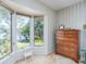 Charming bedroom detail with bay window and serene water views, complete with classic wooden dresser at 840 2Nd St, Clermont, FL 34711