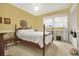 Bedroom with yellow walls, a four poster bed, and classic decor at 840 2Nd St, Clermont, FL 34711