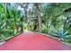 Long driveway with lush landscaping and mature trees at 840 2Nd St, Clermont, FL 34711